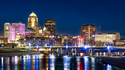 Des Moines, Iowa skyline by night with reflections in Des Moines river. Des Moines is the capital and most populous city in the U.S. state of Iowa and seat of Polk County