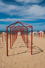 Symmetry of Red Poles and Striped Cabins by the Sea