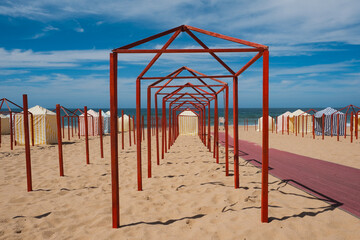 Symmetry of Red Poles and Striped Cabins by the Sea