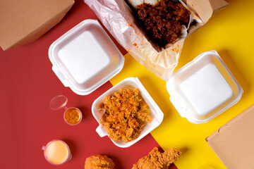 Flat-lay of multiple takeaway boxes with ayam geprek, sauces, and fried chicken on red-yellow backdrop—clean graphic layout for food delivery, online order, and restaurant marketing.