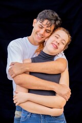A man and a woman are hugging each other