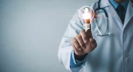 Doctor touches bright light bulb with human silhouette symbolizing innovation and healthcare ideas