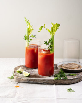 Healthy Virgin Mary mocktail made with tomato juice, garnished with celery and lime, non-alcoholic refreshing beverage in glass.
