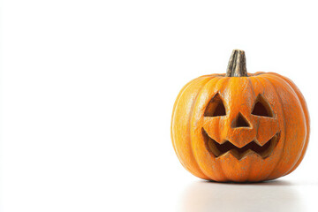 Fototapeta premium A single orange carved pumpkin, a jack-o'-lantern, with a spooky face, sits on a white background, ready for Halloween festivities.