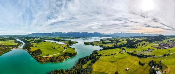 Turquoise waters at the Alpine Lake of Germany, Forggensee Germany, Panorama Photo