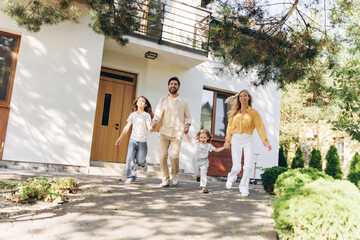 Happy family running out of their new house