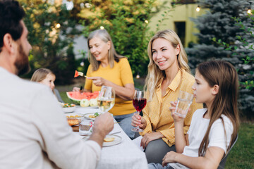Family enjoying outdoor summer dinner in the garden