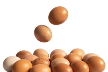 Two brown eggs falling onto a pile of similar eggs against a transparent background. background removed
