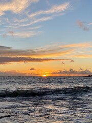 Sea landscape with boats on calm water at sunset