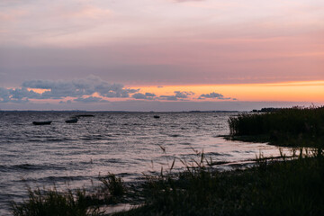 a beautiful orange sunset on the beach of North sea. The sun sets in the sea in the north.