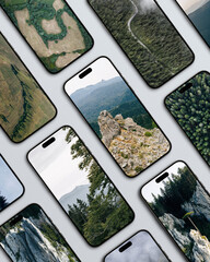 Multiple smartphones with nature images on screens arranged in pattern