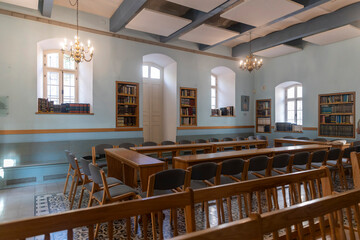 Neve Tzedek district, Tel Aviv, Israel – September 10, 2025: Interior of the Neve Schechter Synagogue with tables and chairs for study, along with bookshelves.