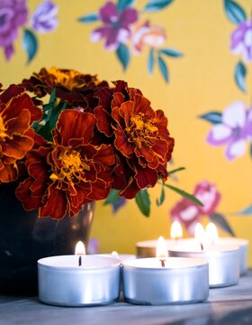 A bouquet of marigolds near candles