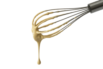 Creamy sauce dripping from a whisk against a transparent background. background removed