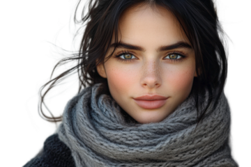 Young woman with captivating eyes and natural look, wearing a cozy gray scarf, captures the essence of beauty in a portrait photograph, showcasing charm and elegance
