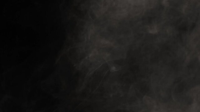 Abstract white smoke in slow motion. Smoke, Cloud of cold fog in light spot background. Light, white, fog, cloud, black background, 4k, ice smoke cloud. Floating fog.