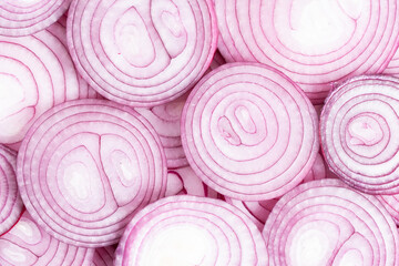 Texture, sliced red onion in background, top view, closeup.