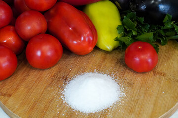 fresh vegetables and salt on a wooden table