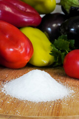 fresh vegetables and salt on a wooden table