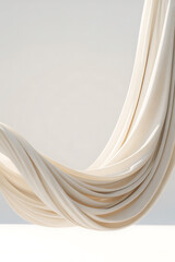 Flowing cream-colored fabric drapes in elegant folds.
