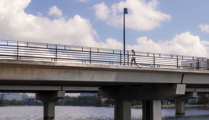 single person walking on a bridge over the river
