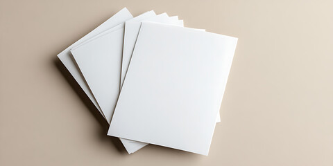Stack of white papers arranged on a beige background. Clean and minimalistic composition perfect for business, document, or design concepts.