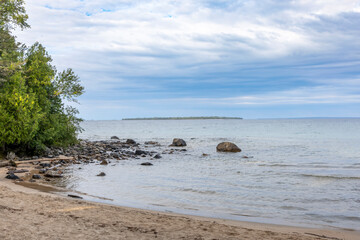 Katherine Cove offers a tranquil escape with its pristine sandy shores and lush forest backdrop along Lake Superior.