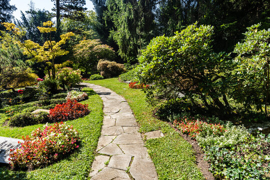 Garden and flowers in the peaceful and sunny Friedhof Fluntern cemetery, a peaceful memorial site in Zurich, Switzerland.