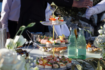 Elegant catering with appetizers and drinks outdoors. Served outdoors at an event or wedding reception.