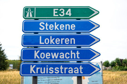 Road direction sign to the E 34 highway and cities nearby in Moerbeke, East Flanders, Belgium