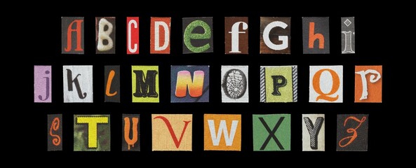 Halloween alphabet set, spooky cut-out letters collage on dark background