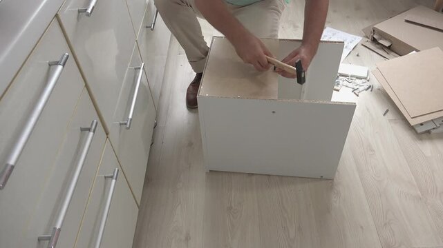 Preparing to assemble a piece of furniture, front view