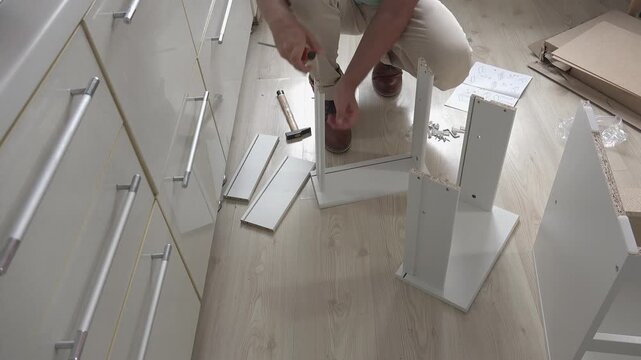 Preparing to assemble a piece of furniture, front view