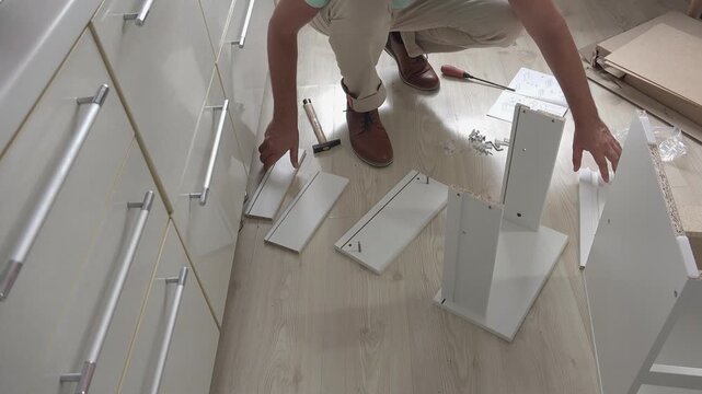Preparing to assemble a piece of furniture, front view