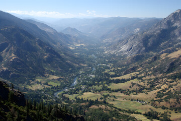Fototapeta premium Mountain valley landscape view with river forest and town from high viewpoint