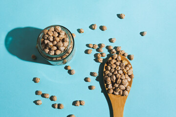 Flat lay photograph of natural cereals and grains, including oats, rice, and chickpeas, in a clean composition with natural light.