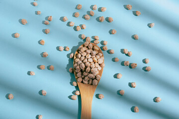 Barley grains scattered from a glass jar on a blue background. Blue background and minimalist style. 