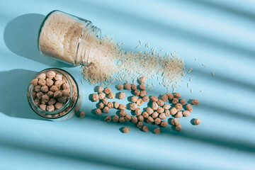 Flat lay photograph of natural cereals and grains, including oats, rice, and chickpeas, in a clean composition with natural light.