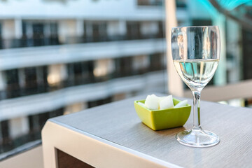 Glass of white wine cafe and fruit light snack on table in sunlight. Atmosphere of delightful event and romantic summer. High quality photo