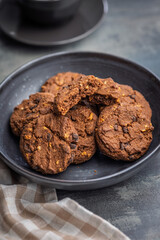 Sweet chocolate cookies in bowl on kitchen table.