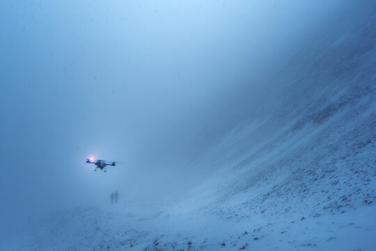 drones equipped with thermal imaging rescue people trapped in avalanches during intense snowfall