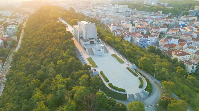 Witness the stunning sunrise illuminating the National Monument at Vitkov Hill. This memorial dedicated to Jan Zizka stands majestically against the backdrop of Prague's skyline.