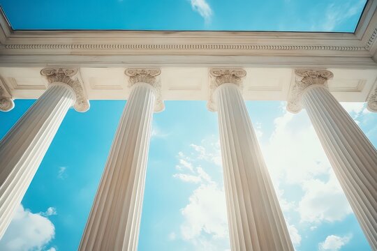 The four pillars are white and are part of a building