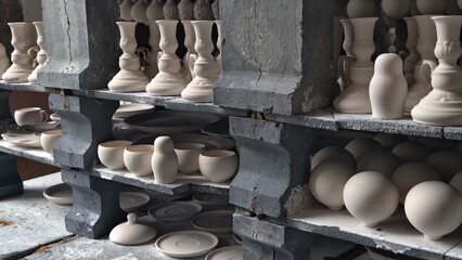 porcelain products on the shelves at the factory, prepared for firing in the kiln. Tableware Making