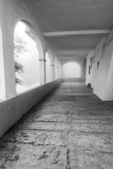 The external misty colonnade of the San Bernardo Sanctuary, in Valdilana Region (Piedmont, Northern Italy) during fall season. Valdilana Panoramica Zegna is a winter ski station and trekking site.