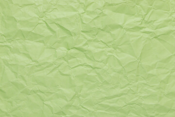 Pistachio green color abstract texture of crumpled paper, empty overlay background with wrinkles