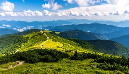 Naklejka premium Lush green mountaintop panorama showcases a winding path through vibrant meadows, overlooking a vast array of rolling hills and deep blue mountain ranges beneath a brilliant, cloud-studded sky.