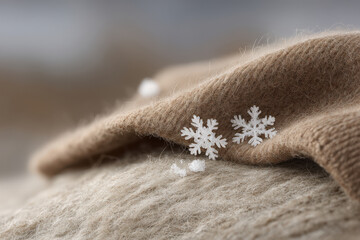 closeup of delicate snowflakes resting on woolen mitten beautifully illuminated by soft moonlight
