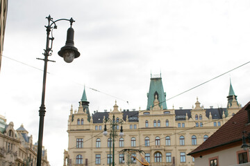 A prominent and large building stands tall, featuring a street light positioned directly in front of it, illuminating the entrance