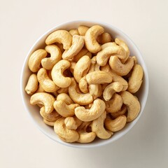 Fototapeta premium Cashews in a white bowl, overhead view (1)